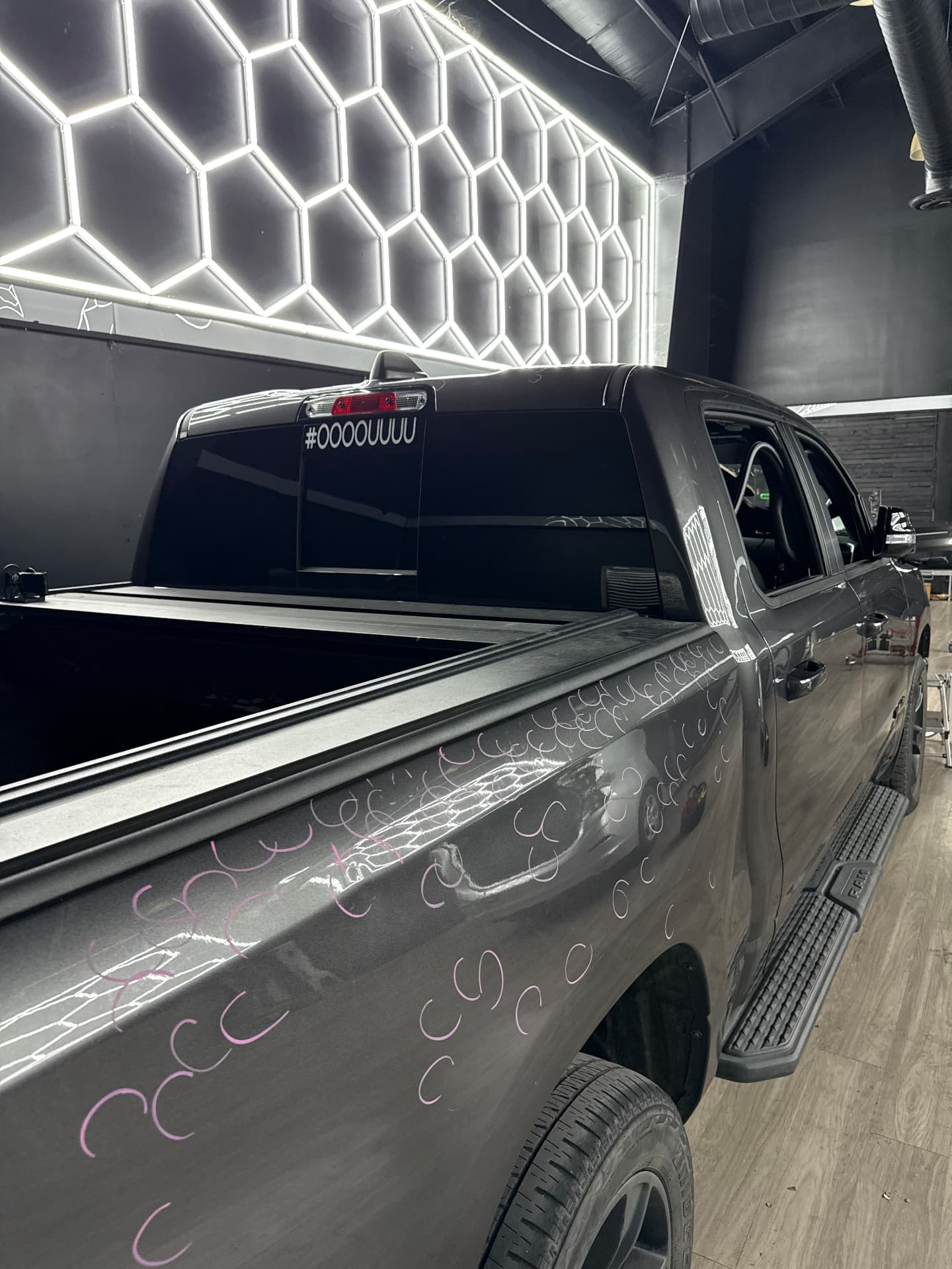 Pickup truck bed with dents marked under PDR inspection lighting